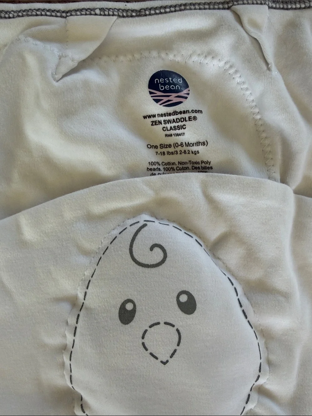 Nested Bean White & Gray Baby Swaddle with Embroidered Face